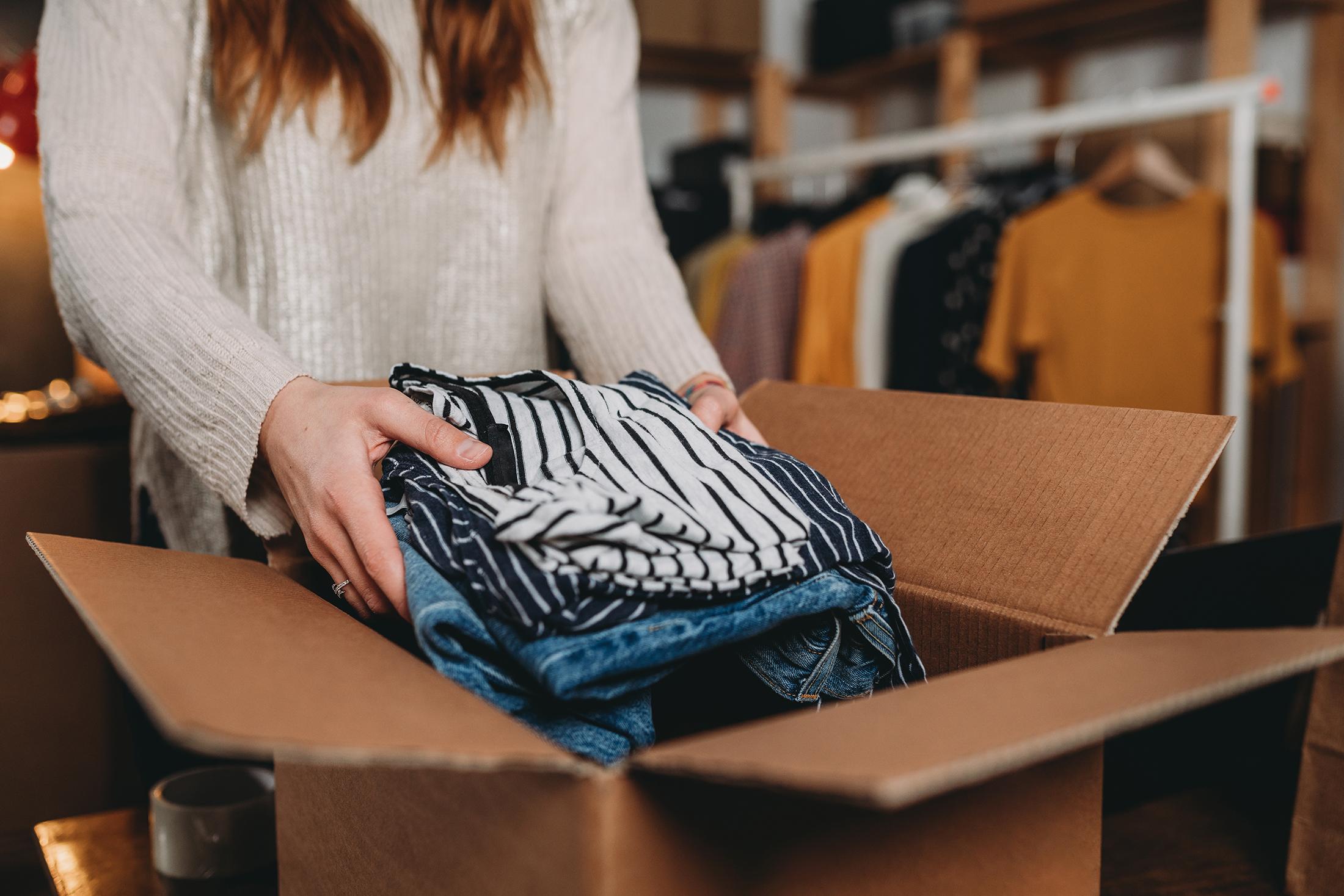 Thrift store clothing donations in a box