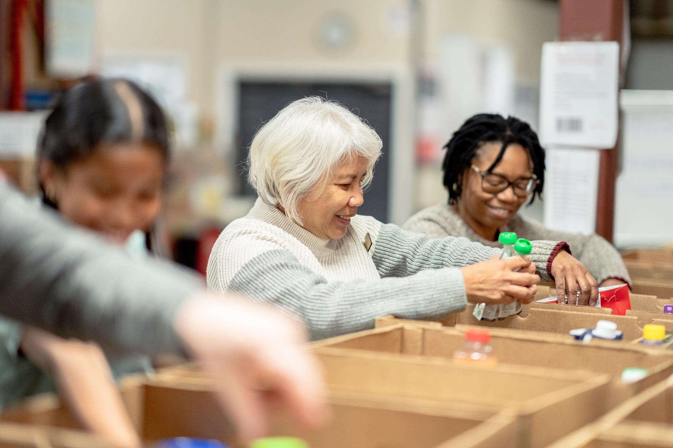 Volunteers helping at a food bank in community